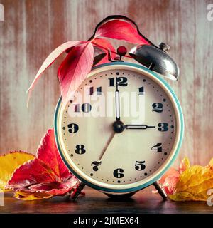 Daylight Savings Time, fall back one hour in autumn. A retro alarm clock Stock Photo