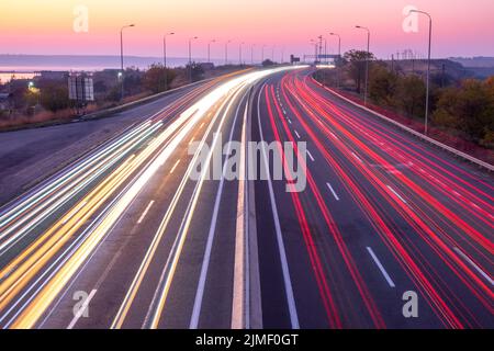 Sunset Car Traffic With Trails on a Suburban Highway Stock Photo