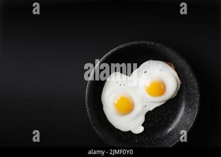 Fried eggs in skillet Stock Photo