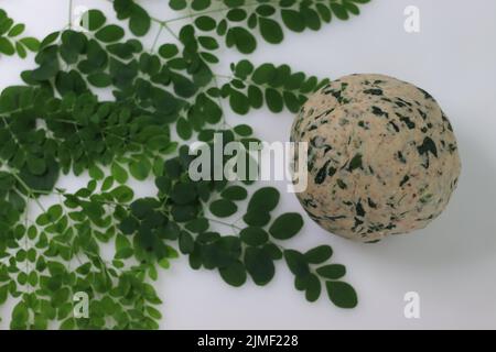 Dough for making Indian flat bread, made of whole wheat flour and spices with moringa leaves added to it. For making healthy indian breakfast called m Stock Photo