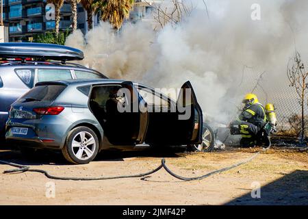 Malaga, Spain. 2nd Aug, 2022. A firefighter puts out a car fire at Calle Pacifico, Madrid. The fire started in the engine of one of the cars and then spread to the car next door. Two vehicles were damaged by the fire. There was no personal injury. (Credit Image: © Francis Gonzalez/SOPA Images via ZUMA Press Wire) Stock Photo