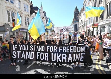 Brighton UK 6th August 2022 - Ukraine supporters  take part in the  Brighton and Hove Pride Parade on a beautiful hot sunny day. With good weather forecast large crowds are expected to attend the UK's biggest LGBTQ Pride festival in Brighton over the weekend : Credit Simon Dack / Alamy Live News Stock Photo