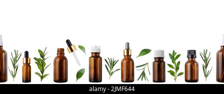 Horizontal seamless flat lay background of dropper and spray bottles with oil and herbs isolated on white banner with copy space Stock Photo