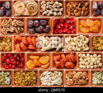 Seamless flat lay food background of dehydrated fruits, seeds and nuts on white. Non-perishable antioxidant gluten free foods co Stock Photo