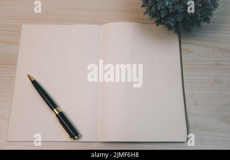Notebooks and diary pen and planner top view wood background. Stock Photo