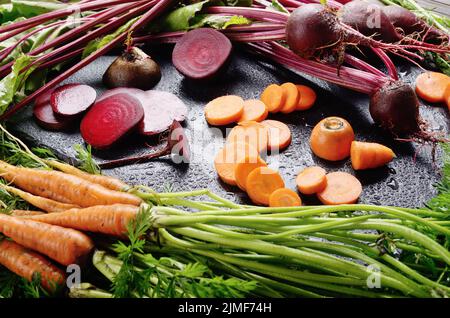 Vegetable background of beets and carrots on kitchen table close up view Stock Photo