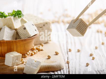 Soy Bean curd tofu in wooden bowl on white wooden kitchen table. Non