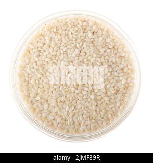 Sesame seeds in glass bowl isolated on white background flat lay closeup view Stock Photo