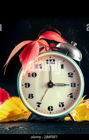 Daylight Savings Time concept, fall back in autumn. A retro alarm clock Stock Photo