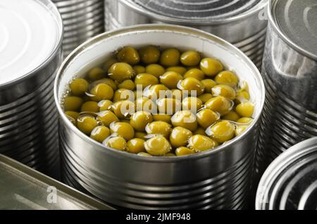 Canned green peas in just opened tin can. Non-perishable food Stock Photo