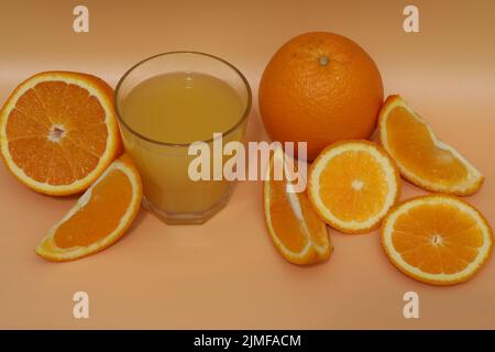 fresh bright orange juice with oranges on yellow background Stock Photo