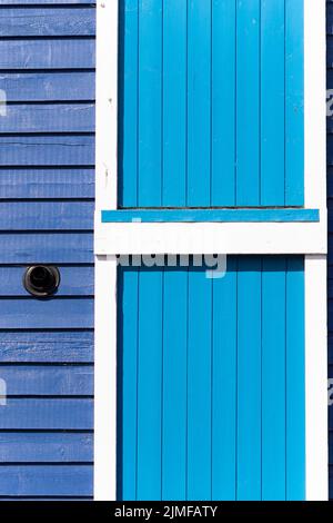 Close up of a wooden building painted in two shades of blue, Littlehampton, West Sussex, UK Stock Photo