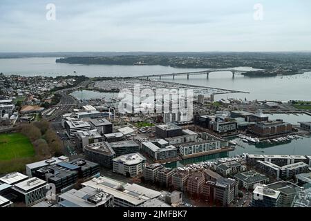 Panoramic aerial view of Auckland City &  Waitemata Harbour looking northwest to the  iconic Auckland Harbour Bridge in the distance. Stock Photo