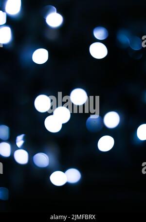 Christmas time and holiday mood concept. Blurred blue xmas tree lights as bokeh background Stock Photo