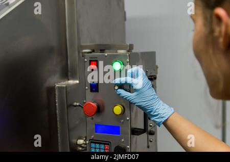 Woman working in industry, adjusting equipament Stock Photo