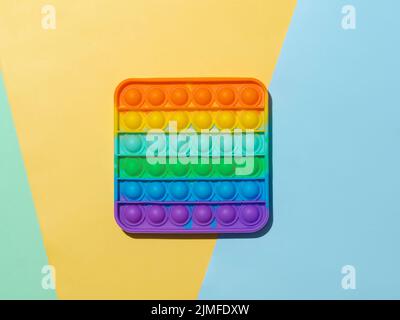 Popit toy on multicolor background, top view Stock Photo