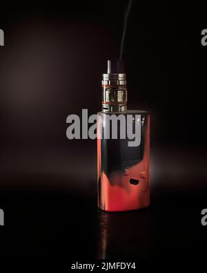 black and red vape machine set against a black background, UK Stock Photo