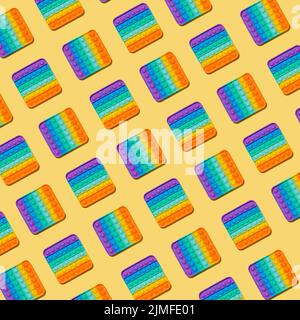 Popit toy pattern on yellow background, top view Stock Photo