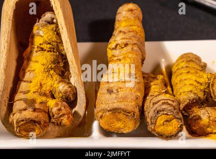 Ginger Roots on a dark background. Stock Photo