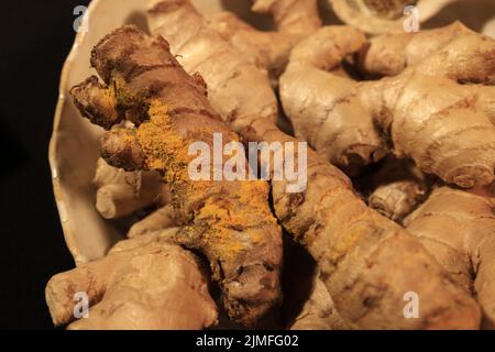 Ginger Roots on a dark background. Stock Photo