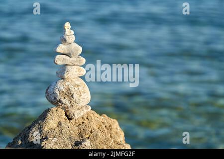 Piled up stones and beautiful view of the Adriatic Sea on the island of Krk in Croatia