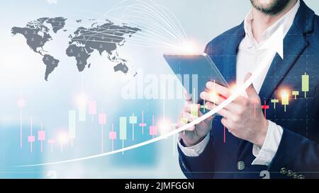 Double exposure of businessman using the tablet with cityscape and financial graph on blurred building background, Business Trad Stock Photo