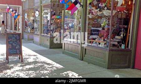 Small unique businesses along the sidewalks in Saugatuck, Michigan on July 9, 2022. Stock Photo