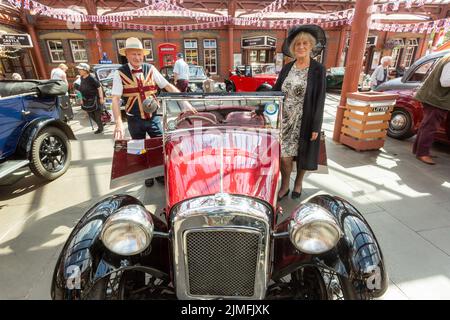 Kidderminster, Worcs, UK. 6th Aug, 2022. Jim Tangye Parker, 78, with his partner Margaret Gould, with their pride and joy - a rare aluminium bodied 1933 Austin Seven EB65 Nippy, at the Severn Valley Railway's Vintage Transport Extravaganza. The annual event has steam engines as well as vintage motor vehicles. Credit: Peter Lopeman/Alamy Live News Stock Photo
