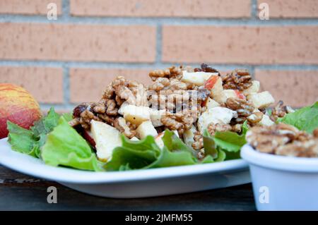 A plate of healthy Waldorf salad with apples,raisins and walnuts Stock Photo