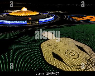 Pathum Thani, Thailand. 06th Aug, 2022. (EDITORS NOTE: Image taken with drone) Aerial view of 100,000 LED lamps in the shape of monks meditating during a mass meditation ceremony to promote world peace at Wat Phra Dhammakaya. Wat Phra Dhammakaya commemorates the World Fellowship of Buddhist Youth (WFBY) 'World Meditation Day' by meditating together for peace and lighting 100,000 LEDs at their temple in Pathum Thani. Credit: SOPA Images Limited/Alamy Live News Stock Photo