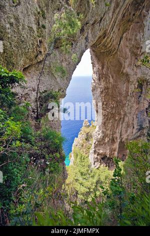 View on the rock gate Arco Naturale at the steep coast of Capri island, Gulf of Naples, Campania, Italy, Europe Stock Photo