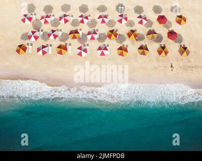 Top view of the beach with umbrellas and sunbeds on the sand. Stock Photo