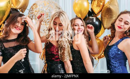 festive party amused dancing girls balloons Stock Photo