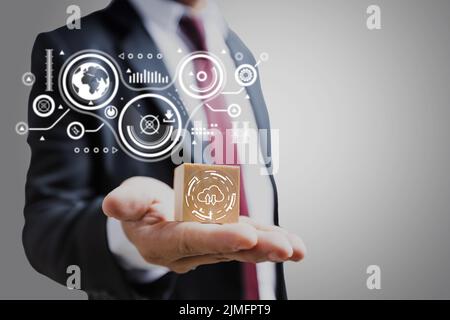 Businessman holding cloud computing diagram show on wood block hand. Cloud technology. Data storage. Networking and internet connection service, prese Stock Photo