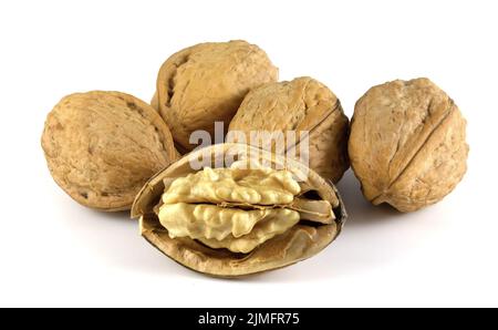 Walnuts isolated on white background. Whole and shelled nuts. Juglans regia is a valuable edible fruit. Stock Photo