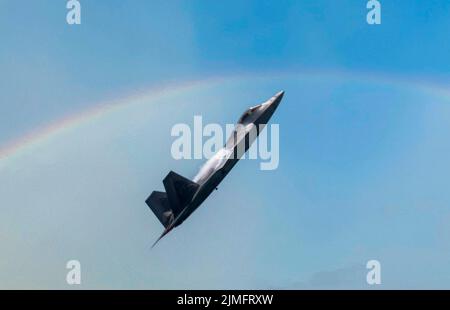 F-22 Raptor Stealth Fighter Climbing at High Speed with Vapor Cone and ...