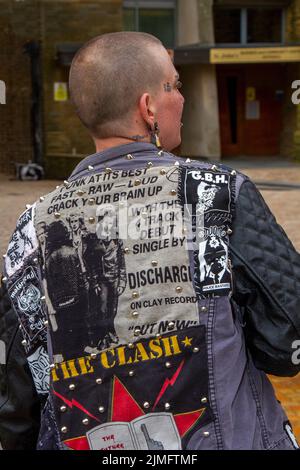 Blackpool, Lancashire, UK. 6th Aug 2022. The punk subculture, ideologies, fashion, with Mohican dyed hairstyles and colouring at the Punk Rebellion festival at The Winter Gardens. A protest against conventional attitudes and behaviour, a clash of anti-establishment cultures,  mohawks, safety pins and a load of attitude at the seaside town as punks attending the annual Rebellion rock music festival at the Winter Gardens come shoulder to shoulder with traditional holidaymakers.  Credit; MediaWorldImages/AlamyLiveNews Stock Photo