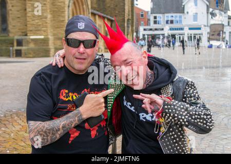 Blackpool, Lancashire, UK. 6th Aug 2022. Talbot & Friend from Leeds. The punk subculture, ideologies, fashion, with Mohican dyed hairstyles and colouring at the Punk Rebellion festival at The Winter Gardens. A protest against conventional attitudes and behaviour, a clash of anti-establishment cultures,  mohawks, safety pins and a load of attitude at the seaside town as punks attending the annual Rebellion rock music festival at the Winter Gardens come shoulder to shoulder with traditional holidaymakers.  Credit; MediaWorldImages/AlamyLiveNews Stock Photo