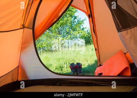 View from inside tent to green lawn Stock Photo