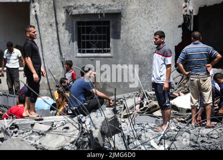 Palestinians inspect a damage building caused by an Israeli air strike in Sheikh Acleyn neighborhood in Gaza. The Israeli military launched deadly strikes against what it said were Islamic Jihad targets in Gaza as tensions continue to rise between Israel and Palestinian militant groups. Stock Photo