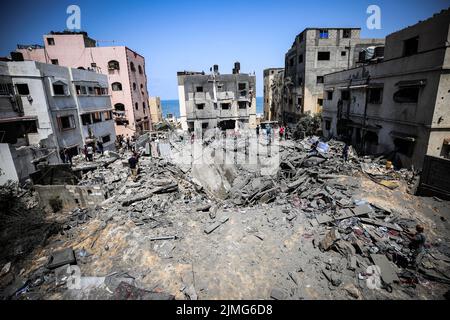 Palestinians inspect a damage building caused by an Israeli air strike in Sheikh Acleyn neighborhood in Gaza. The Israeli military launched deadly strikes against what it said were Islamic Jihad targets in Gaza as tensions continue to rise between Israel and Palestinian militant groups. Stock Photo