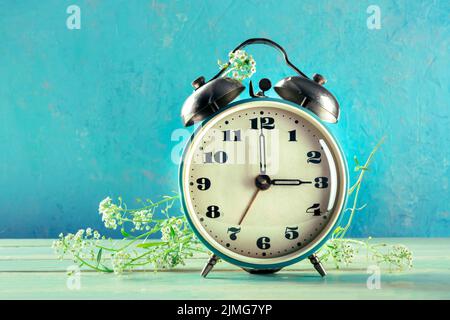 Daylight Saving Time concept, spring forward. A vintage alarm clock Stock Photo