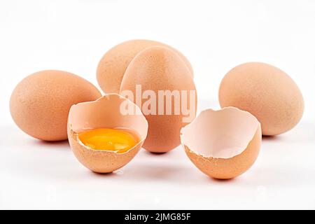 Chicken eggs with broken egg Stock Photo