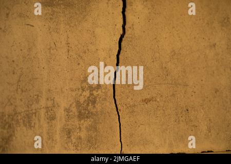 Crack in wall. Texture of concrete wall. Broken surface. Stock Photo