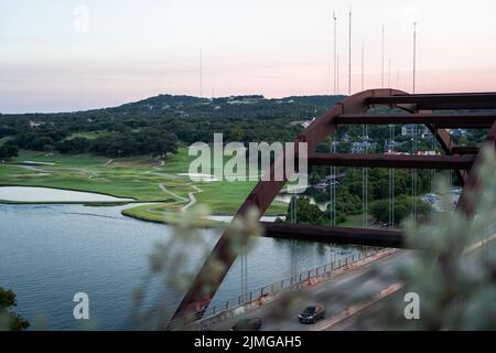 A beautiful view from 360 Overlook Bridge of the lush green lakeshore in Austin, Texas Stock Photo