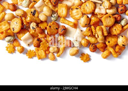 Japanese rice crackers, scattered on a white background, overhead shot Stock Photo