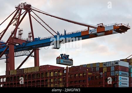 Container being loaded onto a container ship at the Eurogate container terminal, Hamburg, Germany Stock Photo