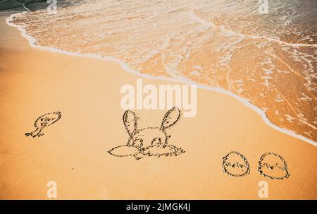 Easter bunny and eggs drawn in sand exotic Easter Stock Photo