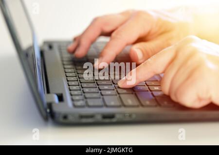 Working from home on the laptop. Wearing casual comfort outfit in home office. Stock Photo