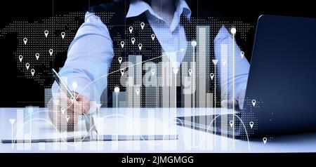 Woman sits at a laptop in front of a holographic chart with growing indicators. Business development, high financial performance Stock Photo